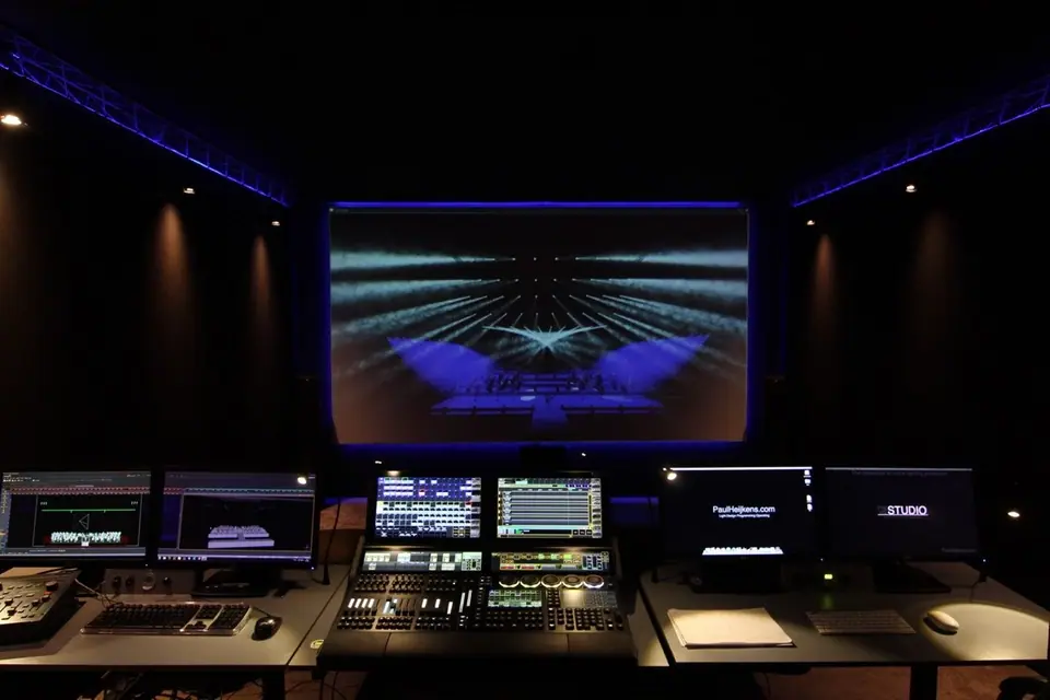 Overzicht van de previs-studio: projectiescherm van 3,7 meter, grandMA3 en werkplekken voor media en timecode